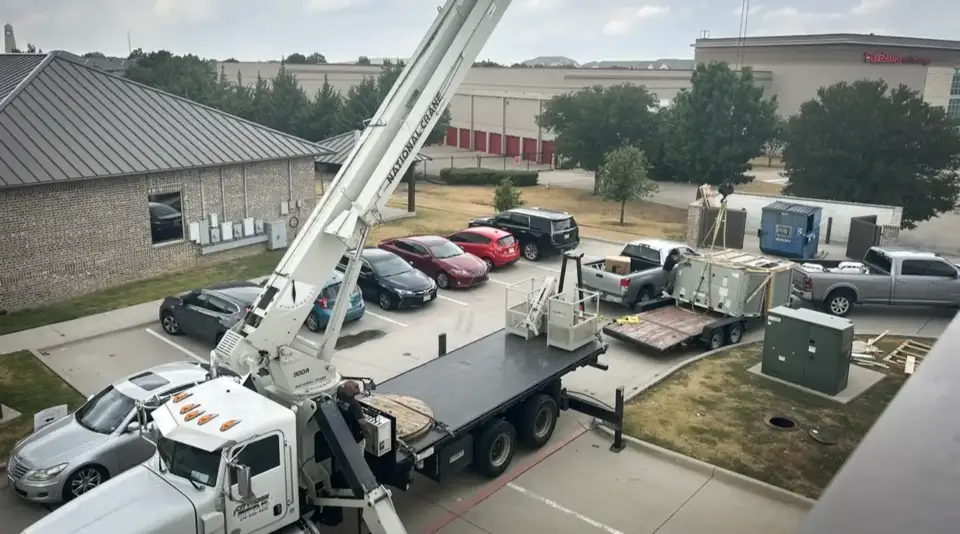Tri-Tech Mechanical using a crane to lift a commercial HVAC unit to a commercial rooftop.