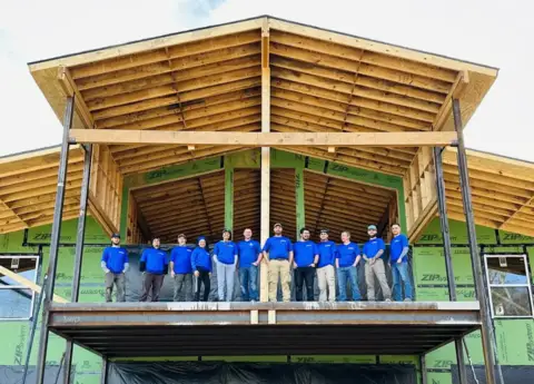 The Tri-Tech Mechanical crew standing in front of a commercial construction project.